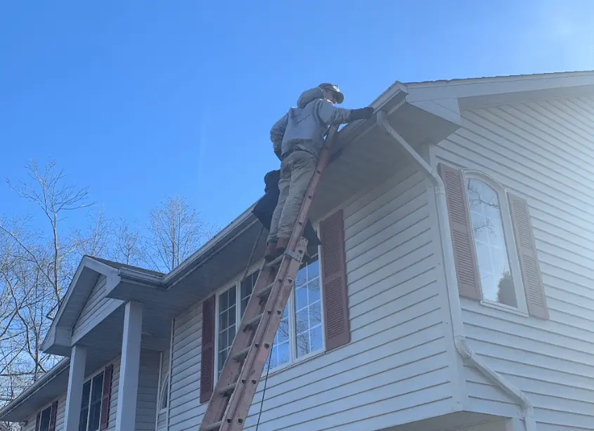 Gutter cleaning and maintenance being performed by Brunswick Power Washing in Brunswick